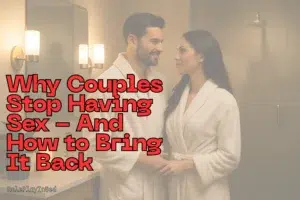 Couple in bathrobes holding hands and smiling at each other, illustrating why couples stop having sex and how to bring intimacy back.